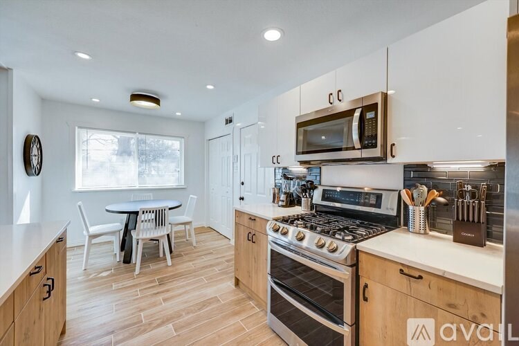 A kitchen with wooden cabinets and a stainless steel oven.