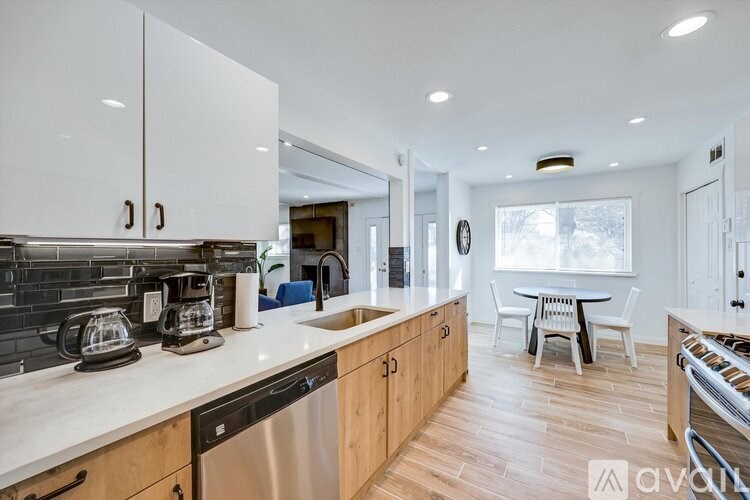 A modern kitchen with wooden cabinets and stainless steel appliances.