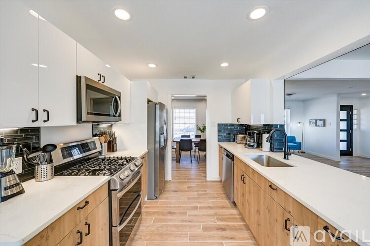 A modern kitchen with wooden cabinets and a white countertop.