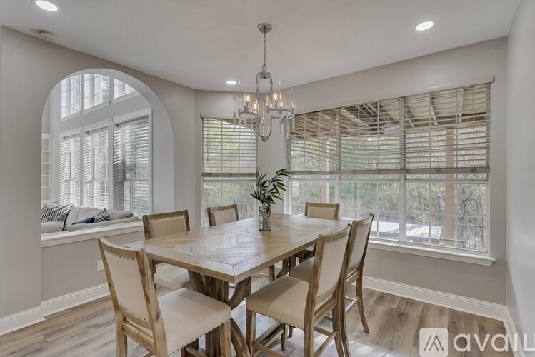 A dining room with a wooden table and chairs.