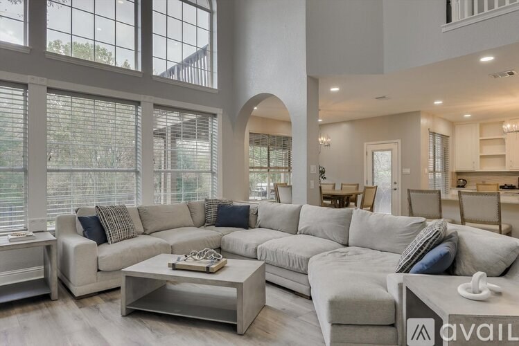 A modern living room with a large sectional sofa and a coffee table.