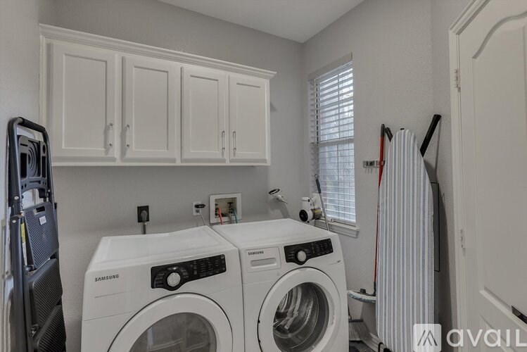 A laundry room with a washer and dryer.