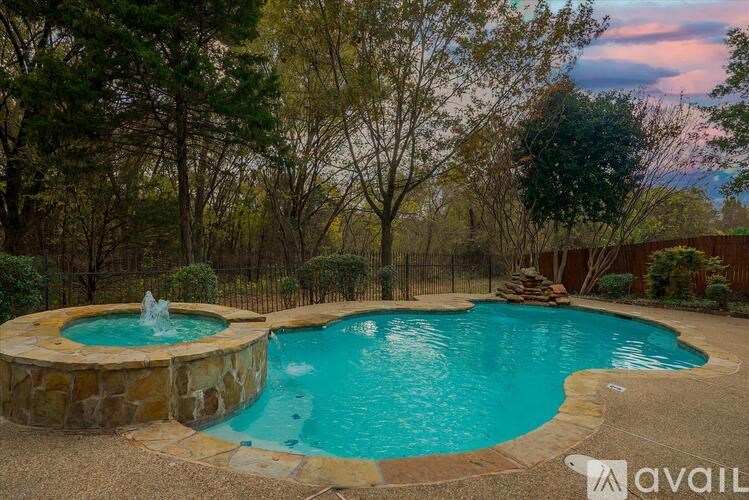 A backyard with a round pool and a fountain.