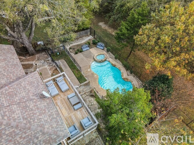 A backyard with a pool and a deck.