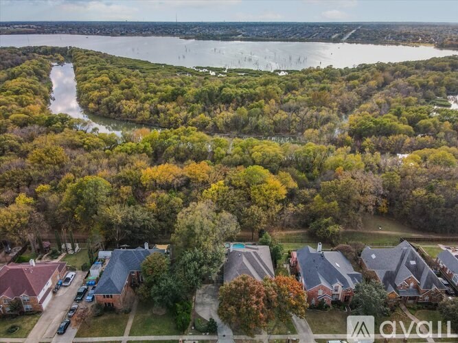 A bird's eye view of a residential area with houses and trees.