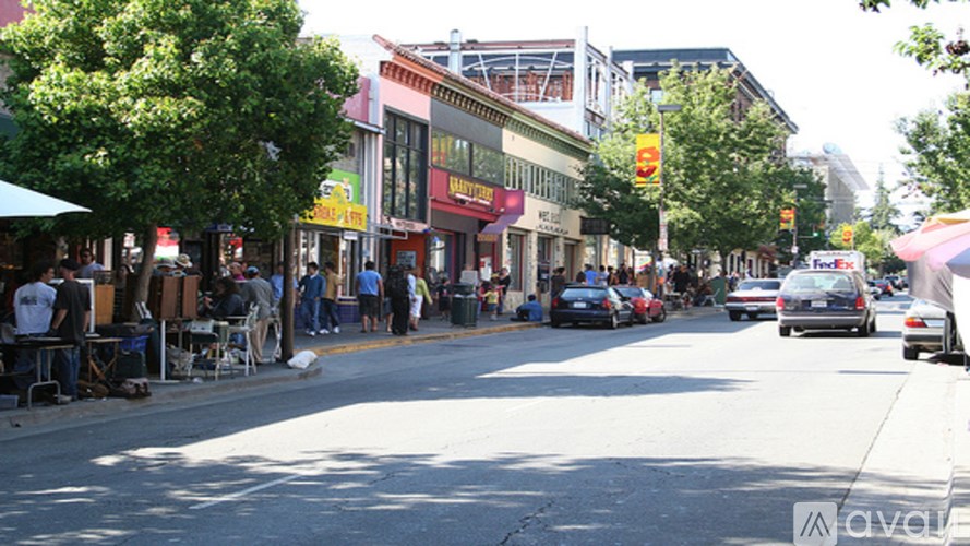 A street scene with cars and people.