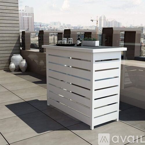 A white reception desk with a city view in the background.