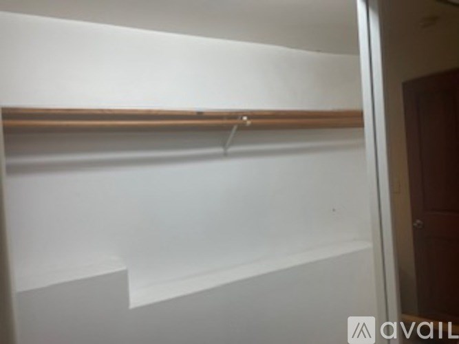A white wall with a coat hanger.