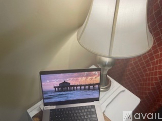 A laptop is open and displaying a picture of a pier.