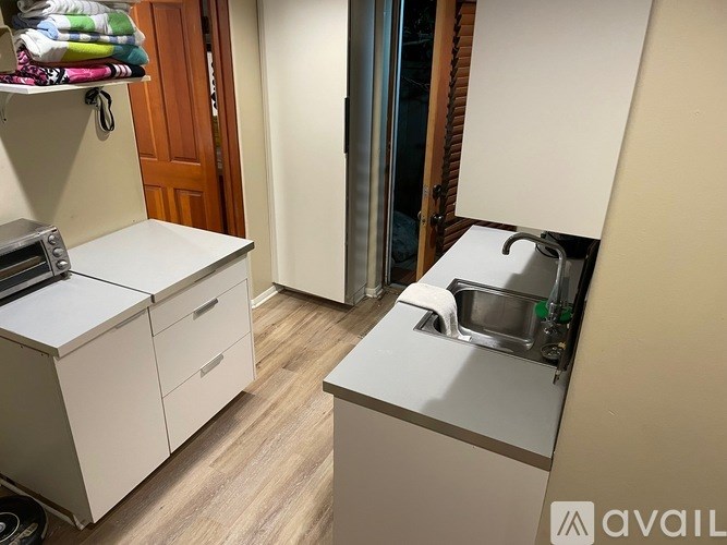 A small kitchen with a sink and a refrigerator.