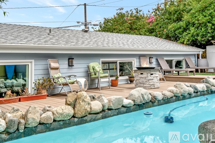 A house with a pool in front of it.