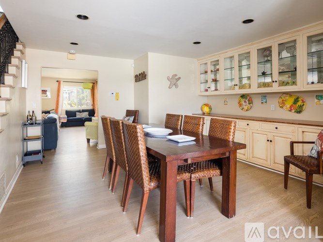 A dining room with a wooden table and chairs.