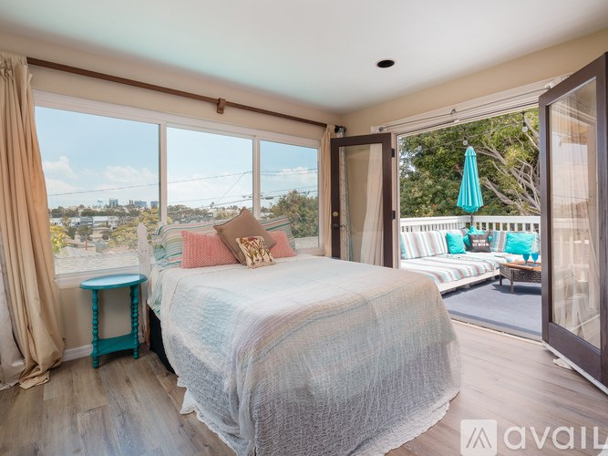 A bedroom with a large bed and a view of the city.