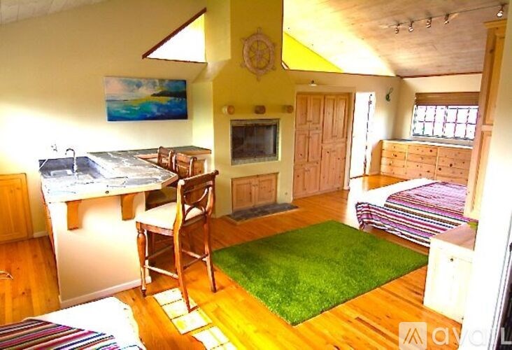 A room with a bed, desk, and chair.