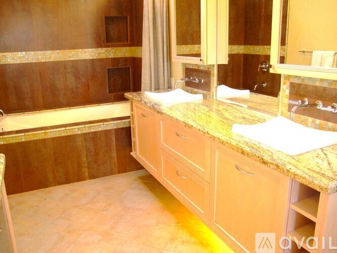 A bathroom with a vanity and a bathtub.