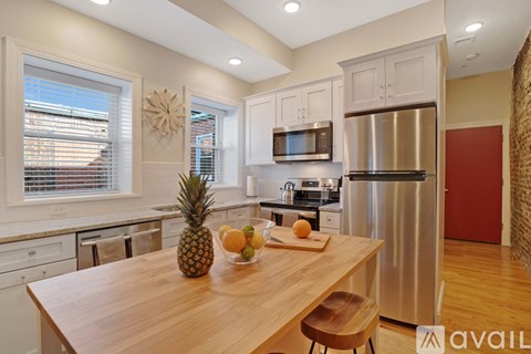 A kitchen with a wooden table and a pineapple on it.
