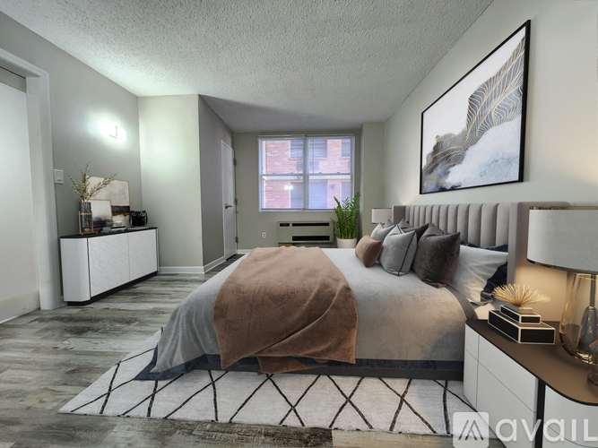 A bedroom with a large bed and a window overlooking a city street.