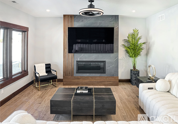 A living room with a fireplace and a white couch.