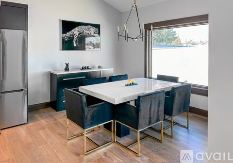 A modern kitchen with a dining table and chairs.