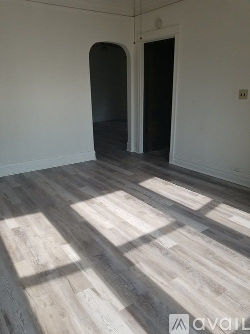 A room with a fan and a door.