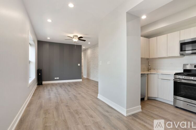 A modern kitchen with a stainless steel oven and microwave.