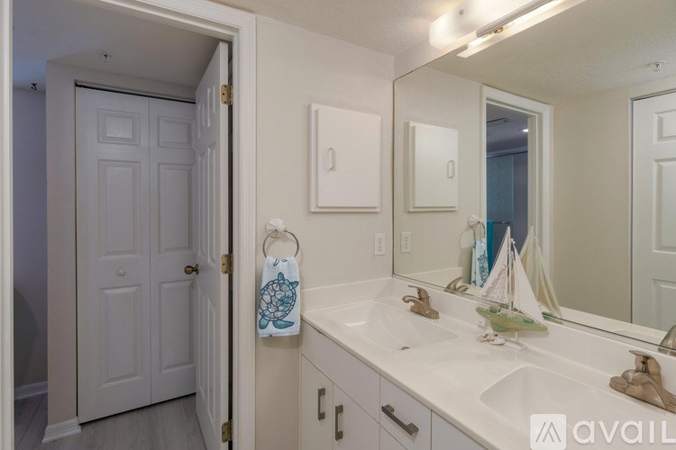 A bathroom with a white sink and a white door.