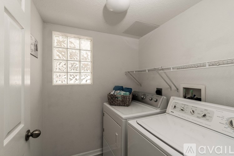 A small laundry room with a washer and dryer.