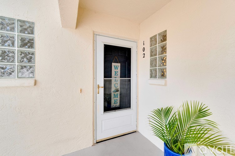 A white door with a glass window and a sign that says "Welcome".