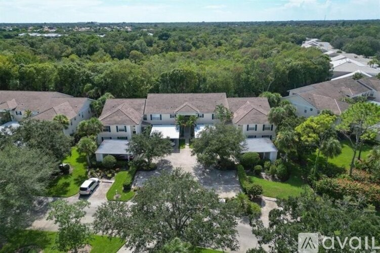 A bird's eye view of a residential area with houses and greenery.