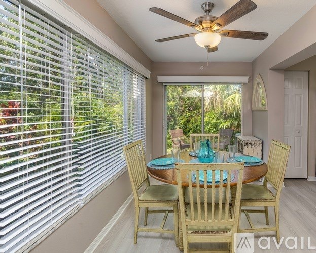 A dining room with a table set for four.