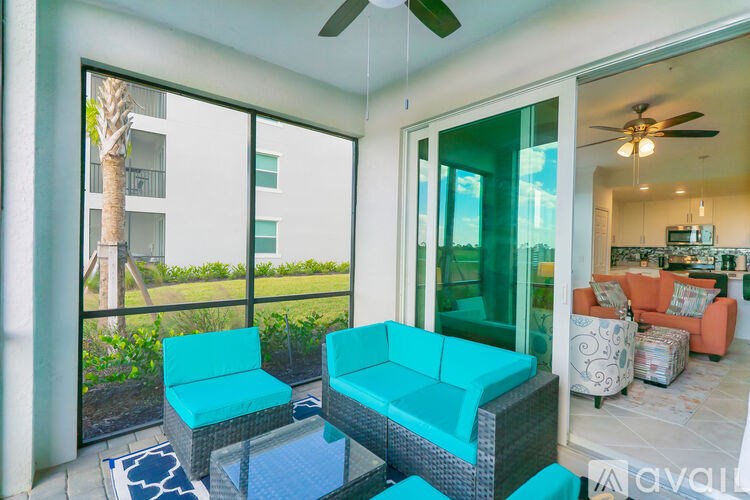 A patio with a table and chairs and a fan.