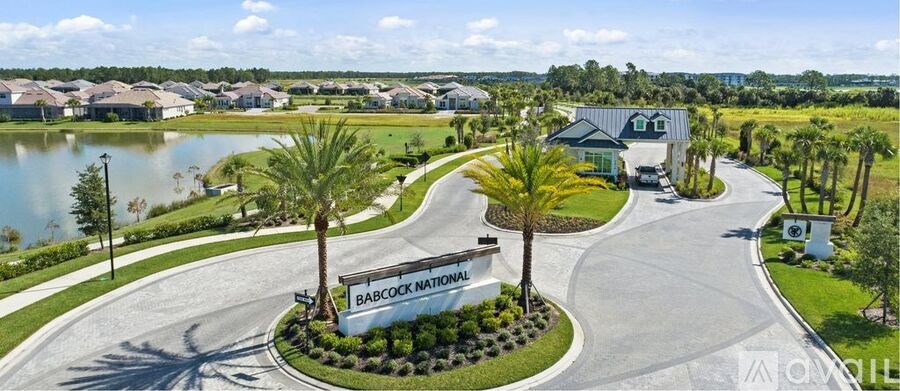 Babcock Nation sign in front of a lake and palm trees.