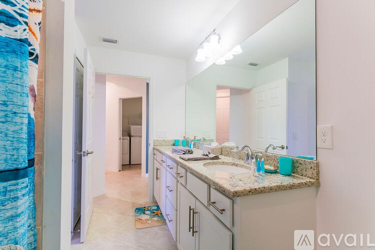 A bathroom with a sink, mirror, and cabinets.