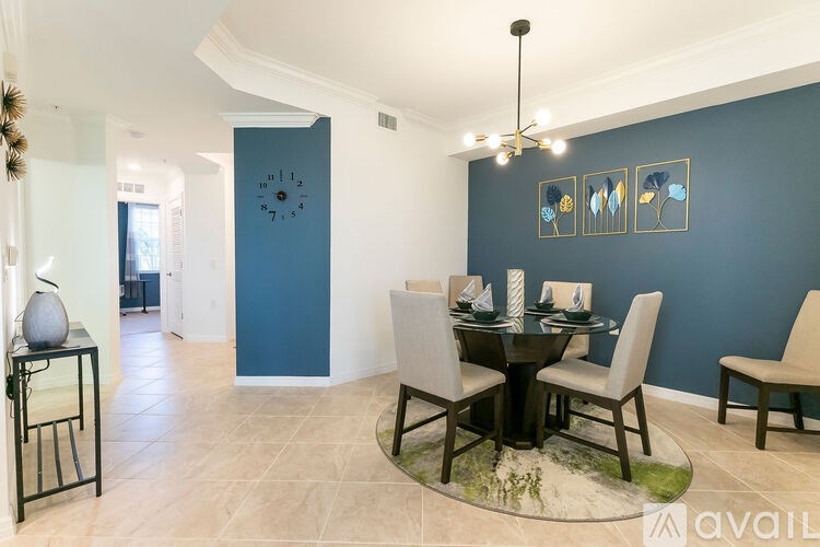 A dining room with a table set for four.