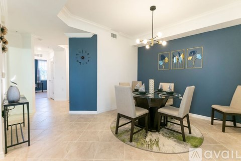 A dining room with a table set for four.
