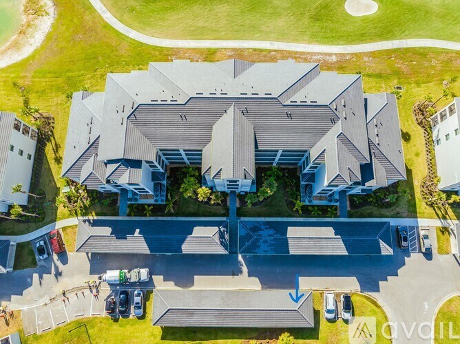 A large building with a parking lot in front of it.