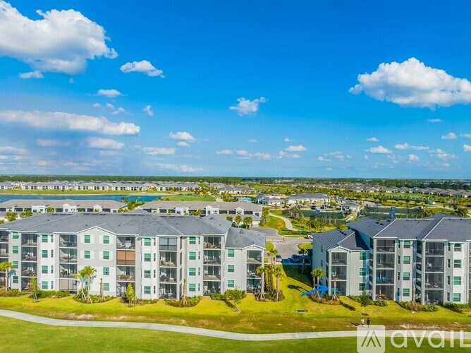 A row of modern apartment buildings with a clear blue sky above.