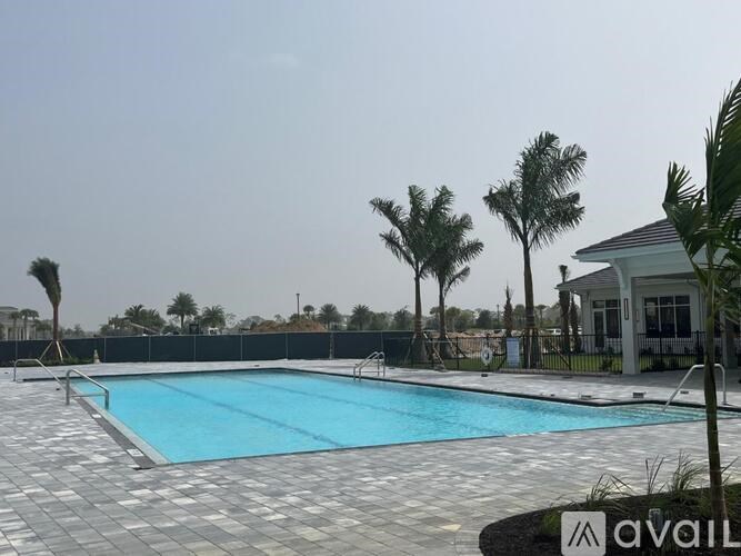 A swimming pool surrounded by trees and a house.