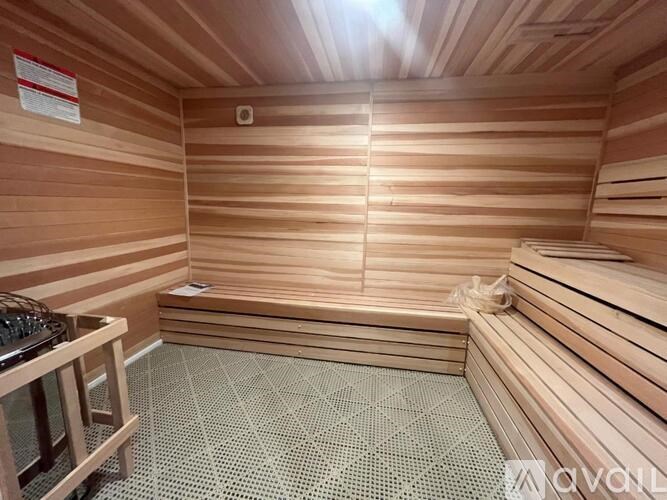 A wooden sauna with benches and a heater.