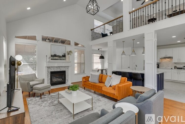 A living room with a fireplace and a television.