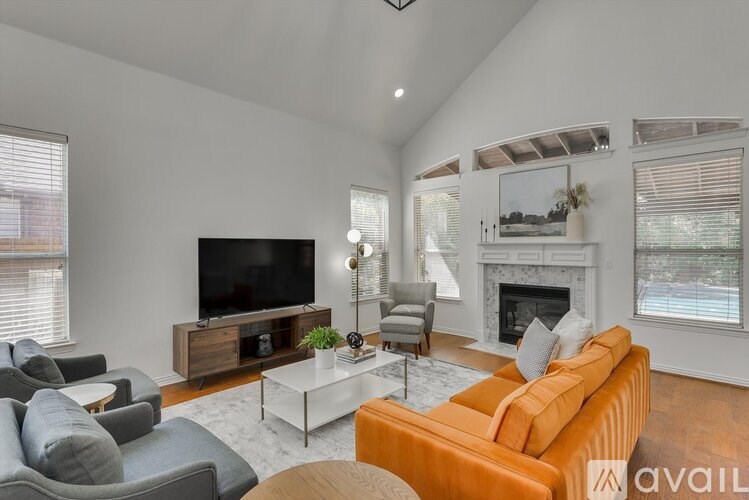 A living room with a television, a fireplace, and a couch.