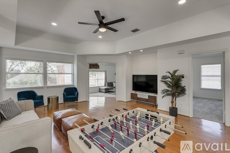 A living room with a foosball table in the middle.