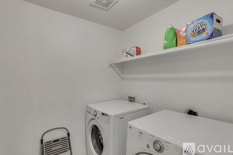 A small laundry room with a washer and dryer.