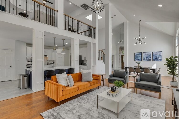 A living room with a white couch and a grey coffee table.