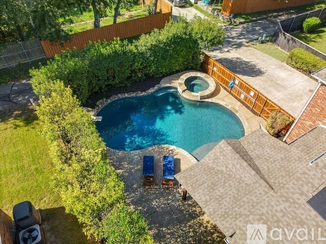 A backyard with a pool and a hot tub.