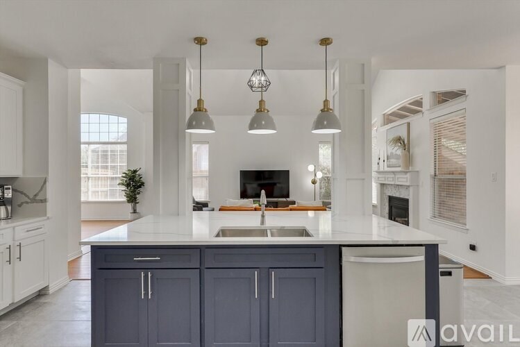 A kitchen with a white countertop and dark blue cabinets.
