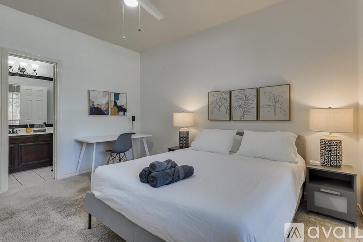 A bedroom with a bed, desk, and chair.