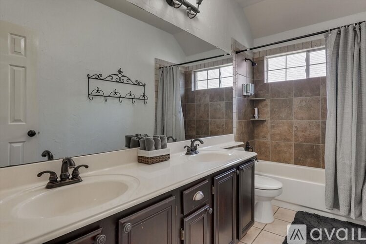 A bathroom with a double sink vanity and a bathtub.