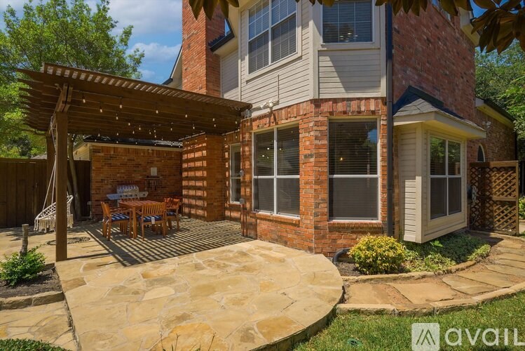 A house with a patio and a stone wall.