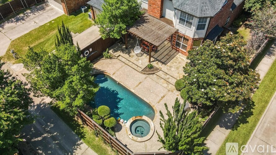 A backyard with a pool and a deck.